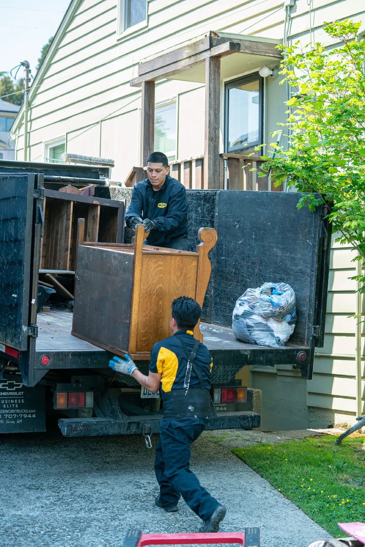 Junk B Gone crew loading truck at a Medina WA estate