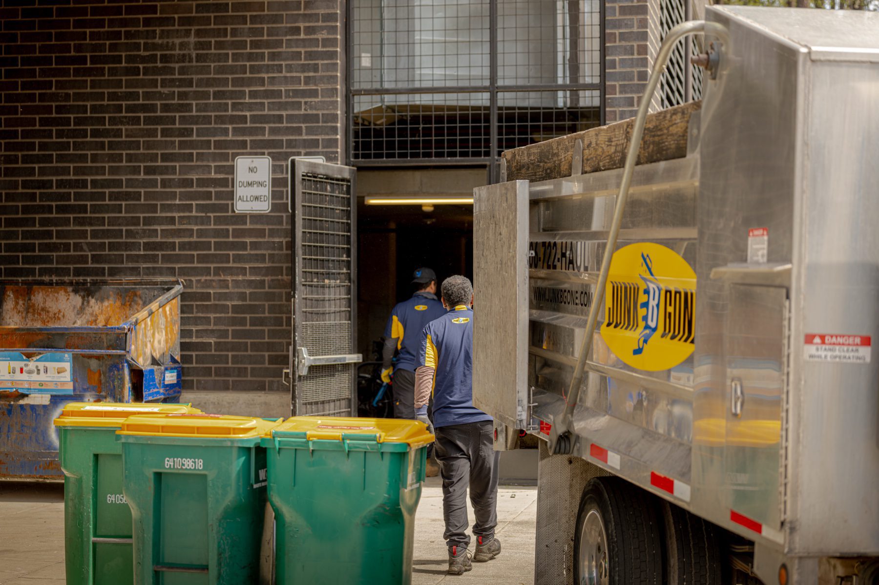 Property cleanout in Seattle - the Junk B Gone crew working alongside the branded truck on a Seattle-area job